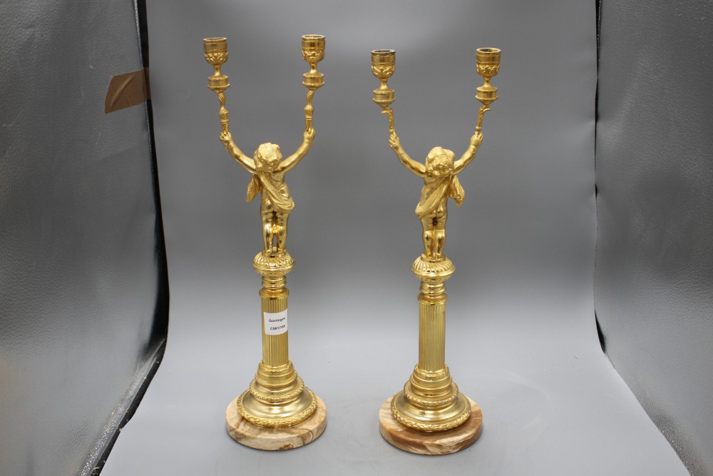 A pair of Italian gilt metal candelabra, with cherub stems and onyx bases, height 52cm